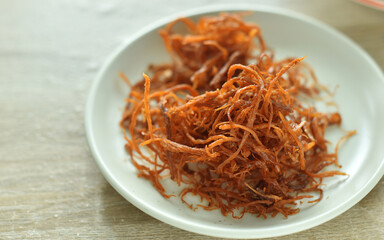 Crispy dried shredded pork on white background.