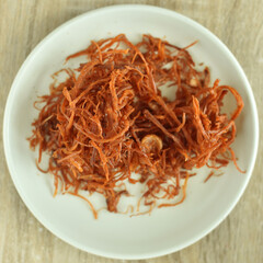 Crispy dried shredded pork on white background.