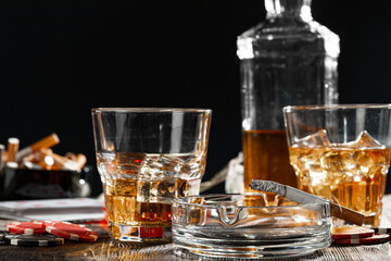Playing poker with whiskey and cigars on table