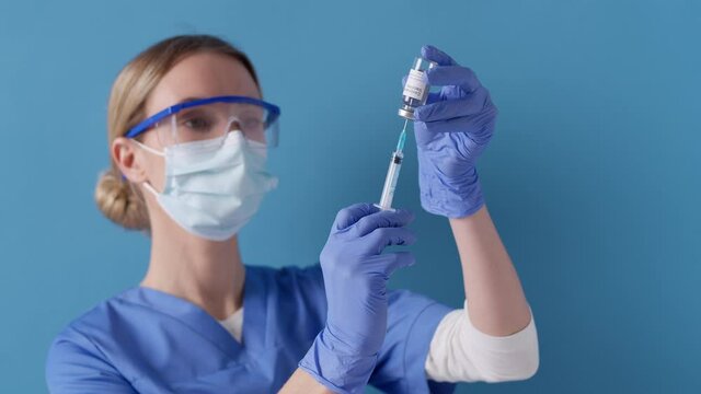 Medical nurse filling syringe with medicine. Vaccinations 