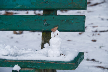 little snowman on the bench
