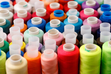 Close up of colored thread coils, thread spools background