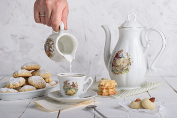 Sister spills the milk on chocolate hot drink to prepare breakfast with Eid Cookies which is called Kahk.