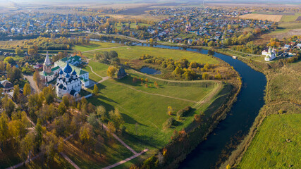 Aerial view of the Kremlin and Kamenka river on sunny autumn day. Suzdal town, Vladimir Oblast, Russia..