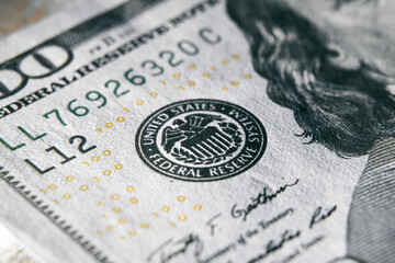 macro photo of federal reserve system symbol on one hundred dollar bill. shallow focus. close-up with fine and sharp texture - obrazy, fototapety, plakaty