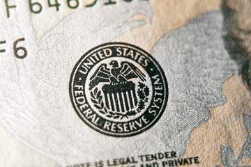 macro photo of federal reserve system symbol on hundred dollar bill. shallow focus. close-up with fine and sharp texture