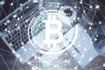 Blockchain theme hologram drawings over computer on the desktop background. Top view. Double exposure.