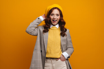 Happy young woman with long red hair in sweater