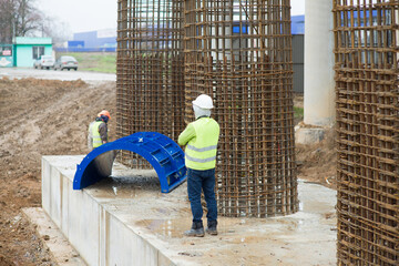 Formwork engineer at the construction site near the reinforcement of the bridge supports