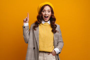 Happy young woman with long red hair in sweater