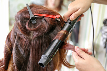 Woman's hair being coloring or painted at the hair stylist beauty salon