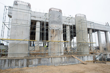Obraz premium Construction of support columns of a transport bridge, road junction