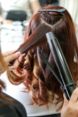 Fototapeta premium Woman's hair being coloring or painted at the hair stylist beauty salon