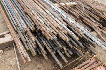 thick, long rods of metal reinforcement at a construction site, close-up