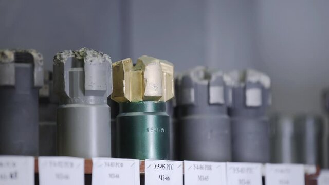 New Drill Bits on shelving in stock. Oil drilling equipment for drilling rig operation on oil platform in oil and gas industry. Brand new PDC Polycrystalline Diamond Compact drilling bit