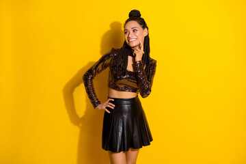 Photo of funny charming dark skin lady wear glamour outfit finger chin looking empty space isolated yellow color background
