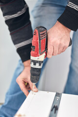 Handyman worker assembling furniture and fixing it.