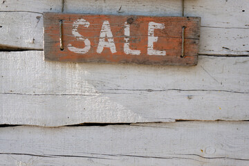 Inscription of the words sale on wooden red boards