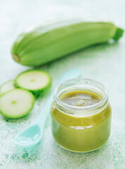 Jar with healthy baby food and zucchini