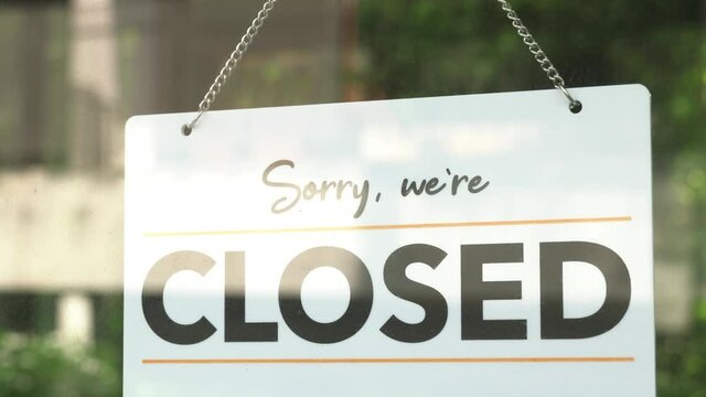 Sorry we are closed, sign on front glass door of a shop. Business closure during coronavirus outbreak.