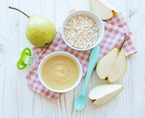 Bowl with fruit baby food and pears