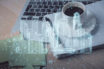 Double exposure of buildings drawing and desktop with coffee and items on table background. Concept of smart city