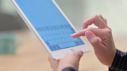 Rear View of Female Hand Writing on Tablet