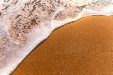 Soft sea wave on a sandy beach.