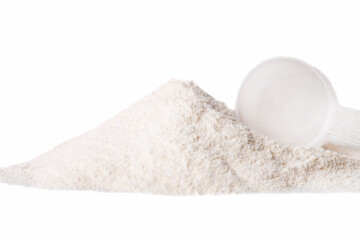 Heap of white protein powder with measuring spoon