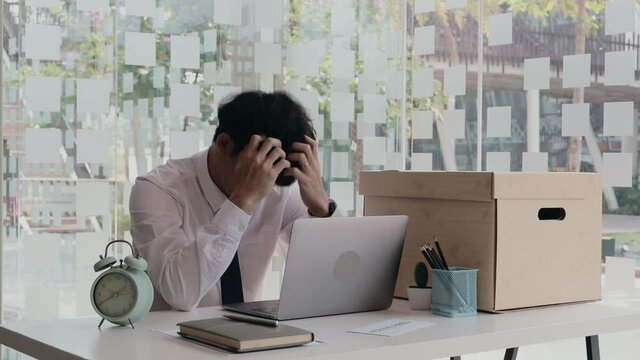 Put the work equipment in the office in a large brown box, Businessmen are keeping work documents and personal belongings due to resignation or being fired, termination of employment.