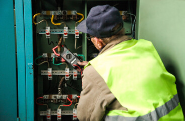 Electrician measures voltage