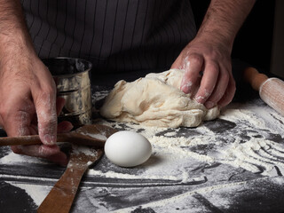 Photo of flour and men hands with flour splash. Cooking bread. Kneading the Dough.