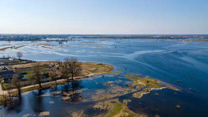 Fototapeta na wymiar Aerial view of river flood. Beautiful flooded meadow. Flying above beautiful Pripyat river when the river is full of water at spring. Nature concept.