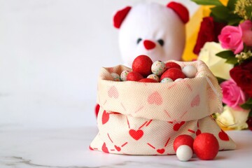 Bouquet of flowers, colorful sugar candies, and a cute teddy bear. A perfect gift combo for birthday and happy valentine's day. Rose flowers. I love you. Happy mothers day greetings. copy space.