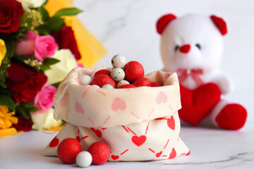 Bouquet of flowers, colorful sugar candies, and a cute teddy bear. A perfect gift combo for birthday and happy valentine's day. Rose flowers. I love you. Happy mothers day greetings. copy space.
