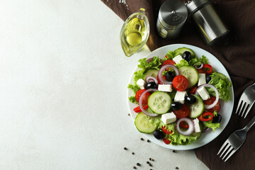 Concept of delicious food with Greek salad on white textured background