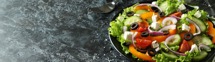 Concept of delicious food with Greek salad on black smokey background