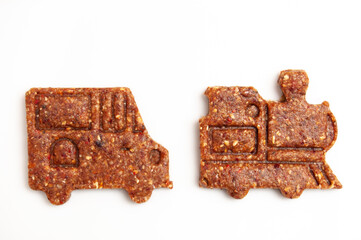 Raw vegan brown cookies on white. less sugar consumption.