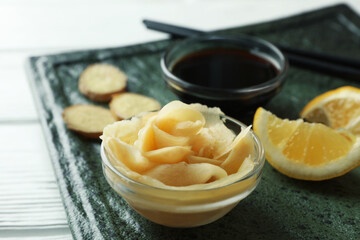Concept of tasty eating with pickled ginger on white wooden background