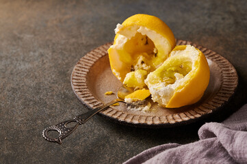 Original dessert fruit lemon according to the idea of French confectioners broken in half - cream based on creamy mascarpone with lemon in shell of chocolate velour. Selective focus