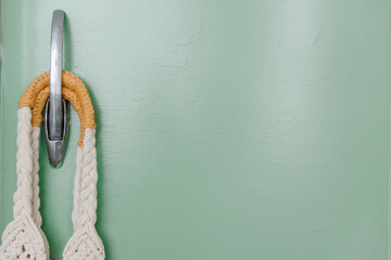 retro refrigerator background painted with green paint, wicker eco bag hanging on a metal handle