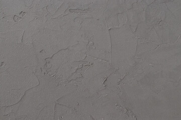 Grey colored textured wall. Gray stucco backdrop close up. Design elements.
