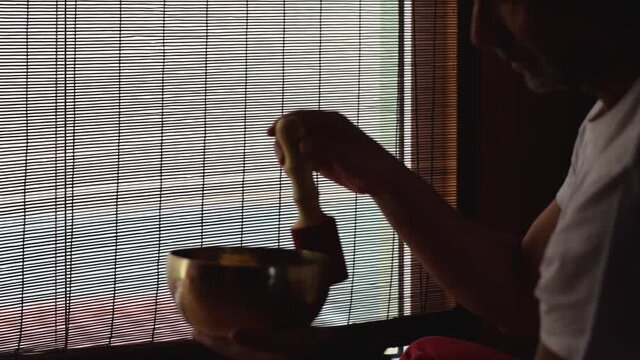 
Person playing tibetan bowl