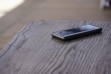 phone on the table of a bar on the Romanian coast. photo during the day. Vama Veche, Romania.