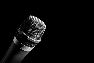 a man holding a microphone on a black background