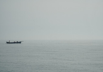 fishing boat in a foggy morning.