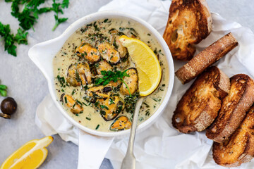 mussels in creamy sauce in a  frying pan.top view