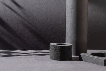 Black abstract geometric shapes with sun harsh shadows frame. Dark modern concept background. Copy space	