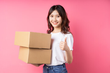 Woman holding the cargo box and smiling happily