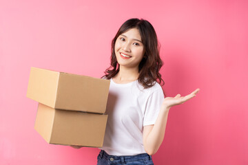 Woman holding the cargo box and smiling happily